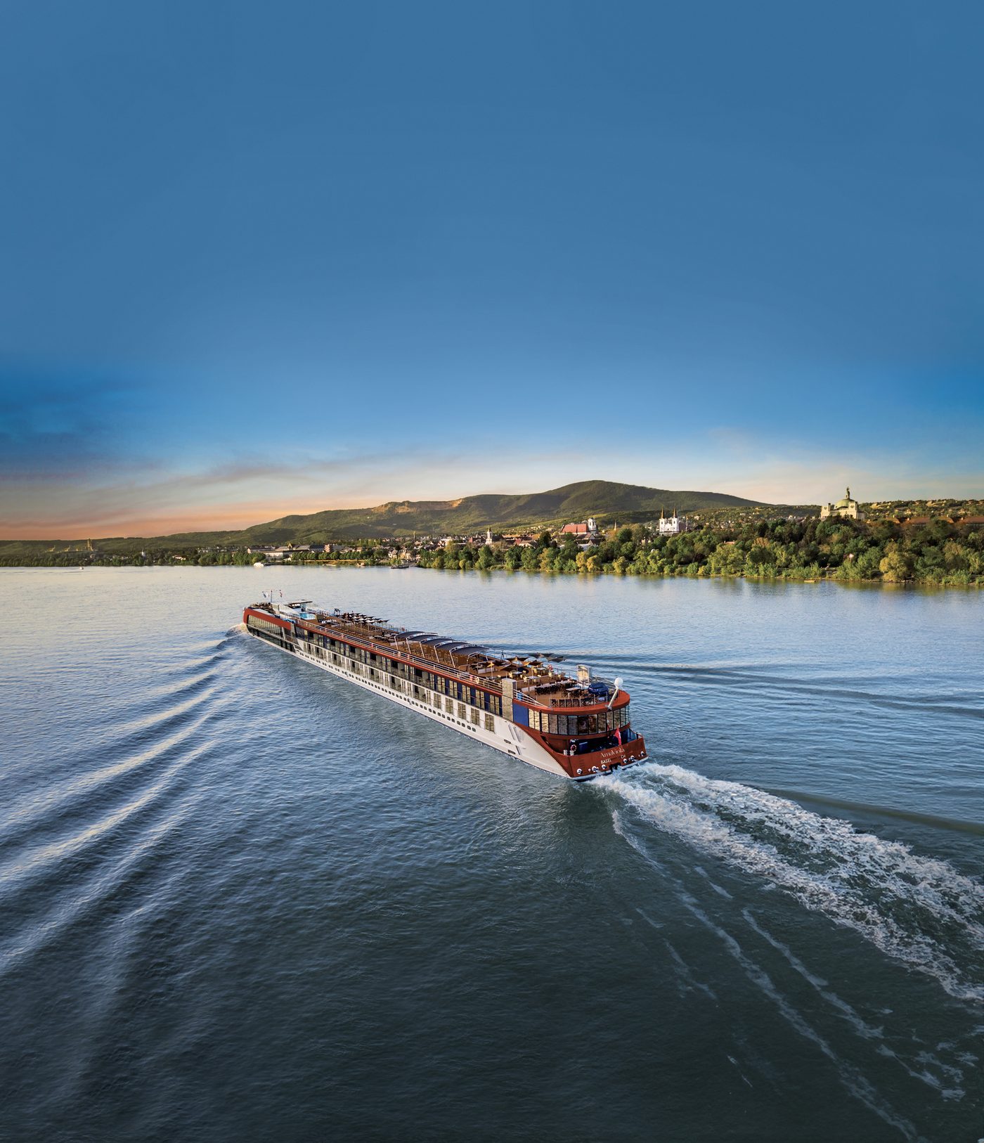 An AmaWaterways river cruise ship at sunset, a vacation planned by T&M Travel